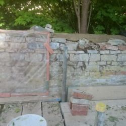Wooden recording frames were placed against the wall to number each stone before dismantling to aid accuracy in reconstruction.