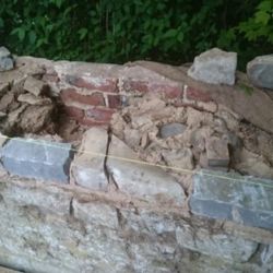 Original stones were reused together with new Lias stones. The core of the wall was filled solid with stone and lime mortar.