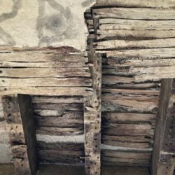 The ceiling beneath was rotten due to water ingress so was to be replaced. Looking upwards through the rotten ceiling laths the original laths that supported the mortar floor can be seen. Although some are still in place, they were rotten and provided no support.